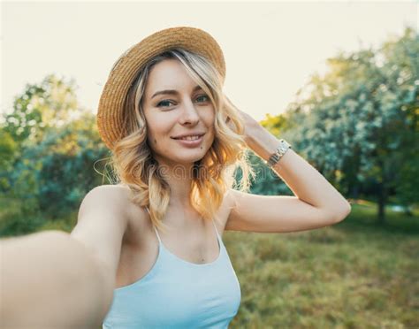 Stylish Modern Girl Taking A Selfie Out In The Park Stock Photo
