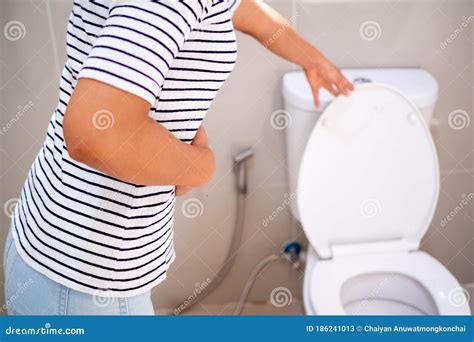 The Girl Has An Upset Stomach Diarrhea Standing In The Bathroom Stock