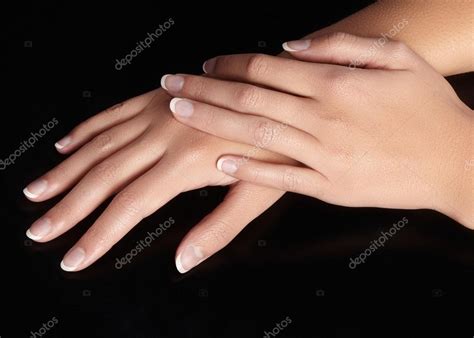 Beautiful Female Arms With Ideal French Manicure On Black Background
