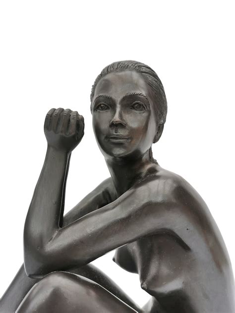 bronze sculpture of a sitting woman