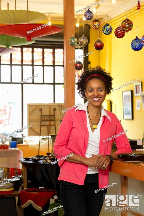 African American Small Business Owner Standing In Shop Stock Photo