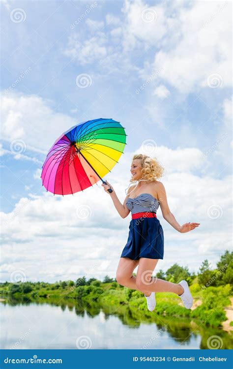 Girl Jumping With A Colorful Umbrella Stock Photo Image Of Happiness