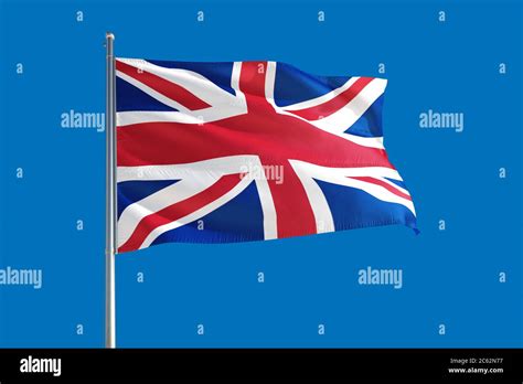 United Kingdom National Flag Waving In The Wind On A Deep Blue Sky