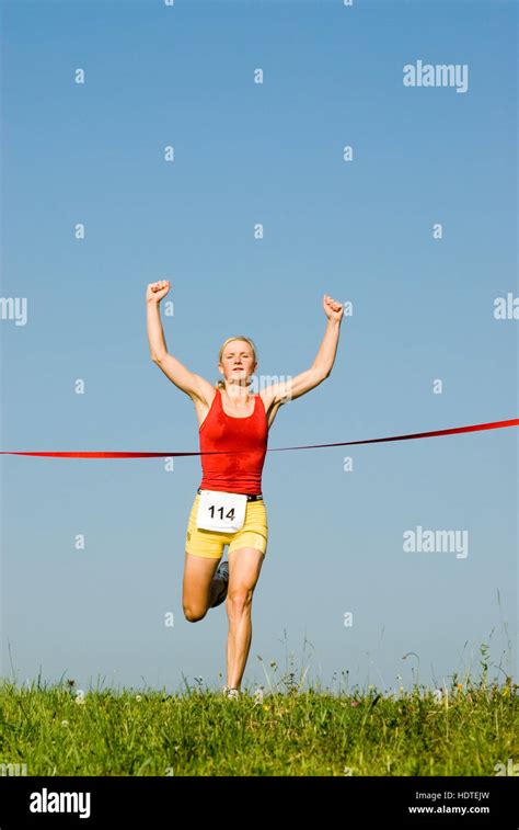 Woman Crossing Finish Line Hi Res Stock Photography And Images Alamy