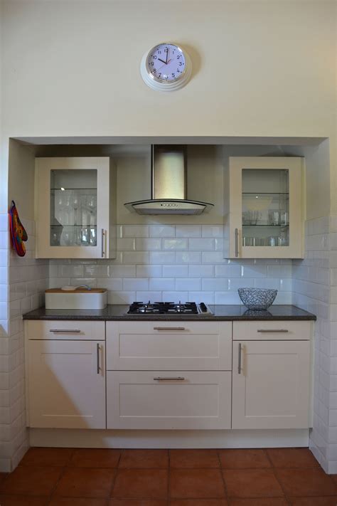 The polar white is a solid colour, but has a subtle pitted appearance due to the glazing and firing process. White minimalist kitchen with rectangular metro tiles ...