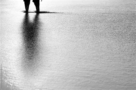 Reflection Of A Man Standing In The Sea Del Colaborador De Stocksy