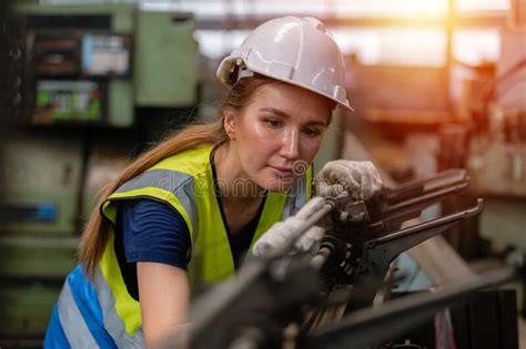 Woman Engineer Wear Hardhat Working At Machine In Factory Female