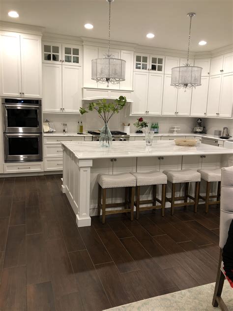 Although usually available in laminate or thermofoil (which can be difficult to paint over), more expensive custom wood. White shaker style kitchen cabinets and white subway tile ...