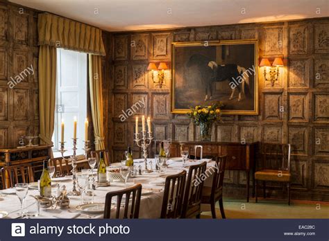 Antiqued walnut jacobean dining room table. Original Jacobean wall panels in dining room with gilt ...