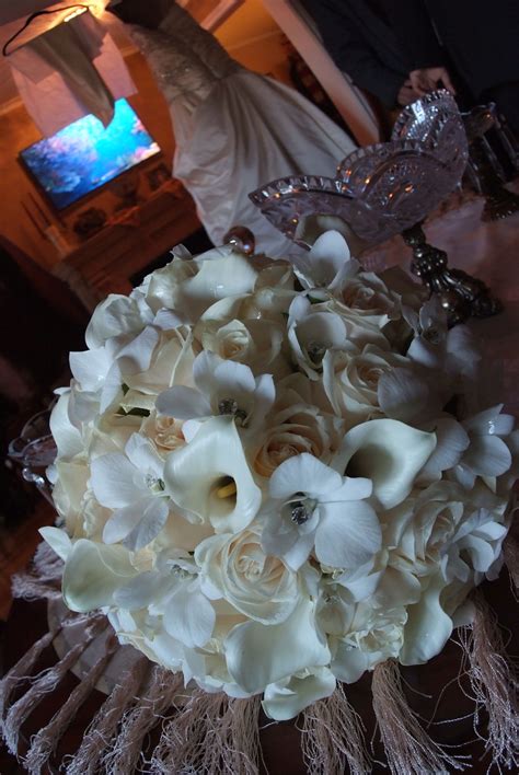 A Classic Bouquet Of Roses Mini Calla Lilies And Orchids Mini Calla
