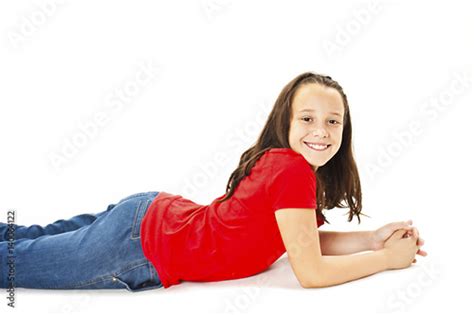 Beautiful Young Girl In Jeans Lying On The Floor Isolated On White