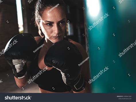 Female Boxer Punching Boxing Bag Warehouse Stock Photo 1636041583