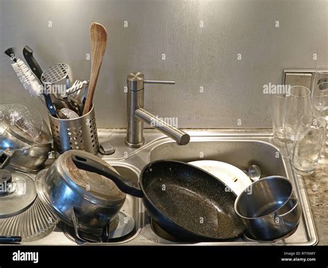 Heap Of Dirty Utensils In The Sink Close Up Of Dirty Kitchen Stock