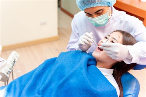 Dentistry And Teeth Healthcare Dentist Check Up Teeth For Asian Patient Doctor Working In