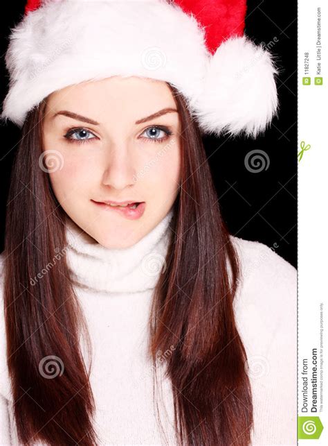 girl biting her lip wearing santa hat royalty free stock