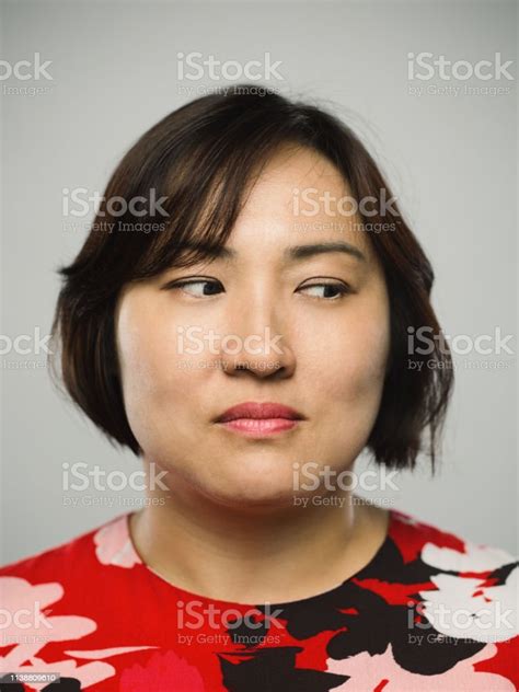 Portrait Of Real Chinese Mature Woman With Blank Expression Looking To
