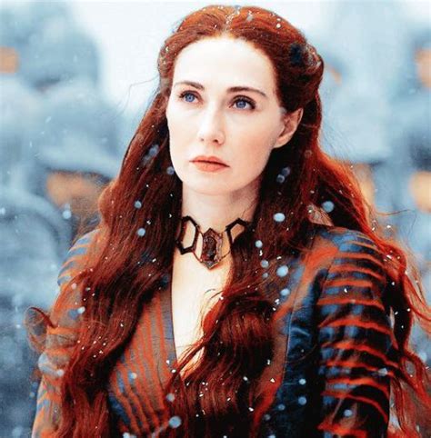 A Woman With Long Red Hair Standing In The Snow
