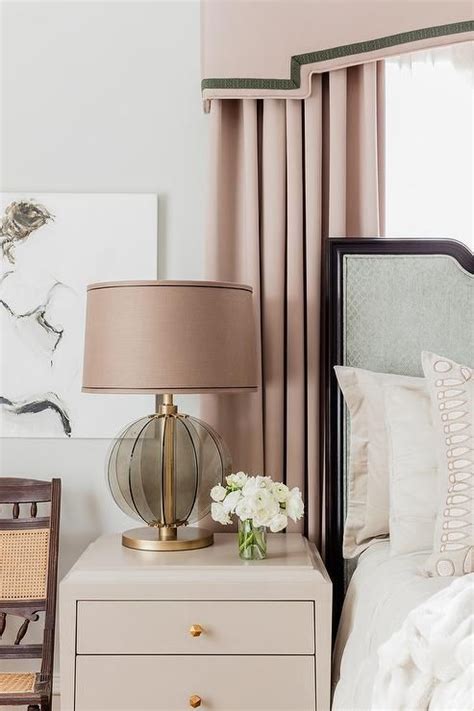 Maybe you would like to learn more about one of these? Pink curtains paired with a pink pelmet box hang behind a ...