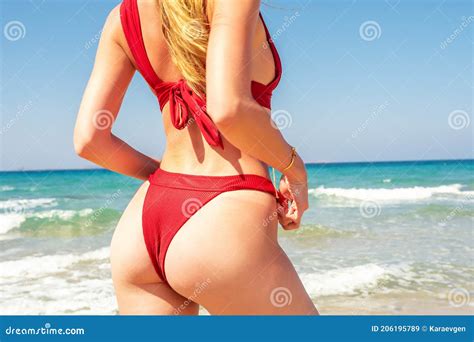 Slim Luxury Girl In A Red Bikini On The Beach Perfect Tanned Body Ass Perfect Figure Stock