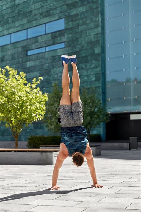 Young Man Exercising And Doing Handstand Outdoors Stock Photo Image