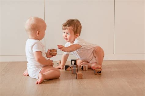 Cute Little Babies Playing With Wooden Blocks Stock Photo Image Of