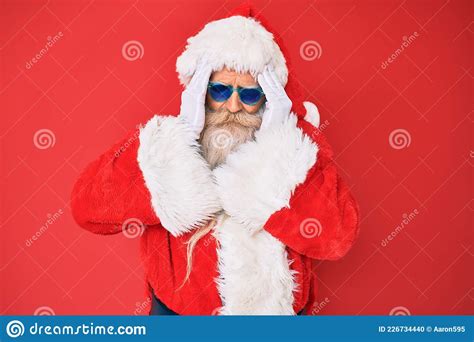 Old Senior Man Wearing Santa Claus Costume And Sunglasses Suffering