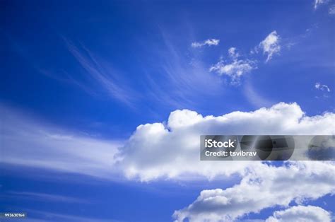 Blue Sky With White Fluffy Clouds On Bright Sunny Day Stock Photo