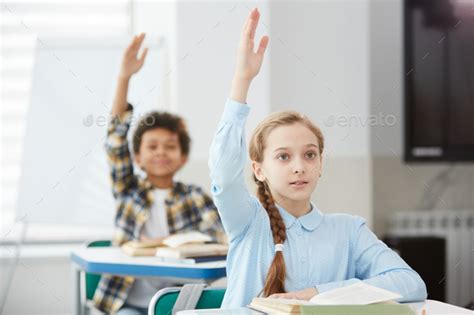 Children Raising Hands In School Stock Photo By Seventyfourimages