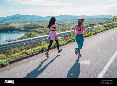 Fit Sporty Girls Running Jogging Outdoors Stock Photo Alamy
