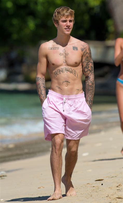 justin bieber looks buff while taking a shirtless beachside stroll in barbados