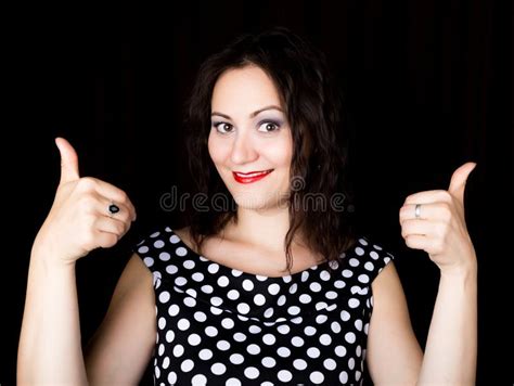 Close Up Woman Looks Straight Into The Camera On A Black Background Shows Various Signs Hands