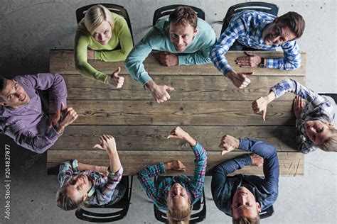 People Sitting Around Table With Thumbs Up Stock Photo Adobe Stock