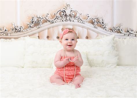 Portrait Of Baby Girl On Old Fashioned Bed By Evan Pollock In Her
