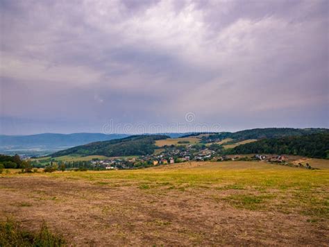 Landscape With Dry Meadows Forest Village In The Valley And Cloudy