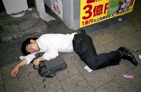 photographer documents the common phenomenon of drunk japanese businessmen snoozing in public