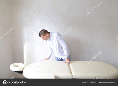 Professional Male Massage Therapist Preparing To Receive Patient Stock