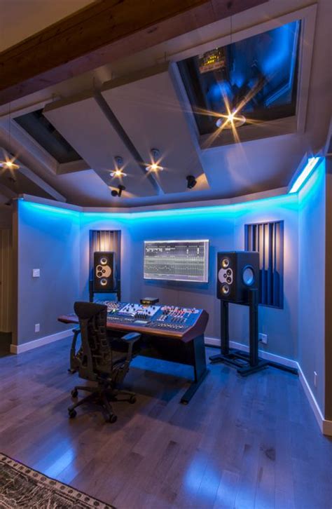 a home recording studio with blue lighting and sound equipment