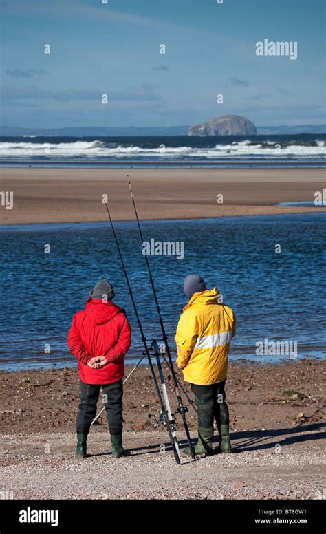 Two Men Sea Fishing Belhaven Bay Beach East Lothian Scotland Uk