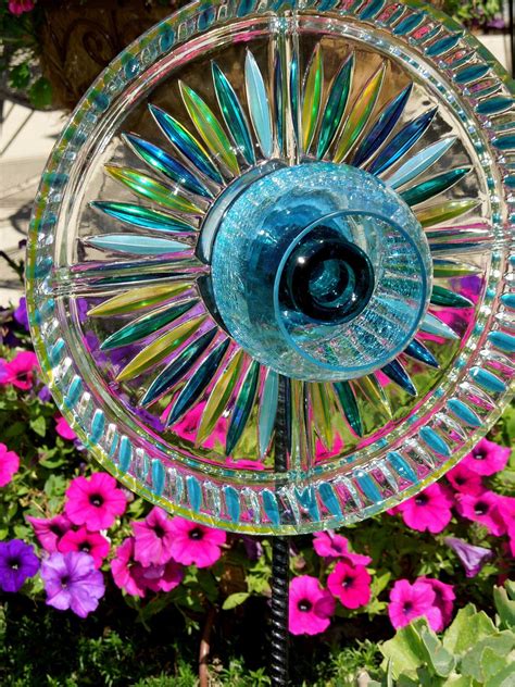 I have seen some vintage dish and plate flowers on pinterest and thought making my own from some inexpensive dollar tree glassware and glass paint would add a pop of pizazz to. garden art made out of glass dishes | GARDEN stakes YARD ...
