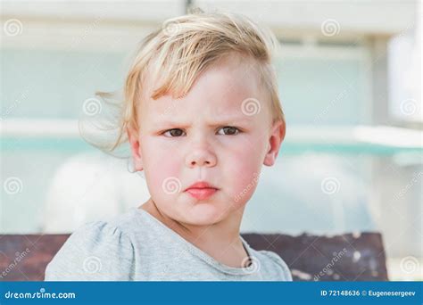 Portrait Of Confused Cute Caucasian Blond Baby Girl Stock Photo Image