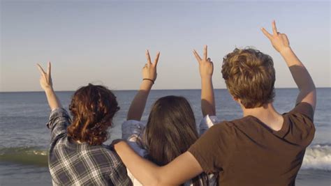 Group Of Teens Hold Up Peace Signs At Sunset Then Walk Away Slow Motion Stock Footage Video