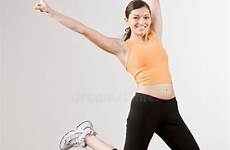 air woman excitedly jumping mid athletic strong stock