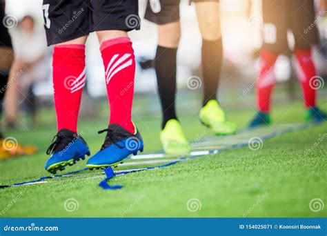 Soccer Player Jogging And Jump Between Marker For Football Training
