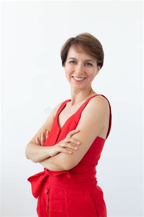 Confident Business Woman Wearing Red Dress Standing With Crossed Arms