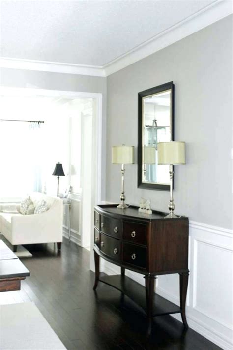 The ottoman stands on top of a gray tone on slate tiles lead to a light gray mudroom bench painted in benjamin moore revere pewter and fitted with drawers located under a white seat cushion. Revere Pewter Sherwin Williams Agreeable Grey Vs Repose Grey ... | Living room paint, Perfect ...