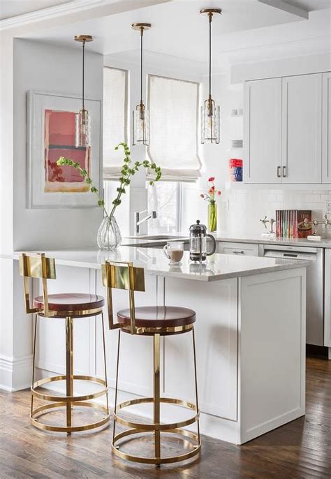 A lower countertop areas gives prep surface for baking and use of small appliances. Charming small white kitchen boasts a sink fixed in white ...