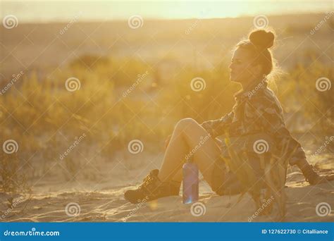 Woman With Bottle Of Water Sitting On Seacoast At Sunset Stock Photo Image Of Female Scenics
