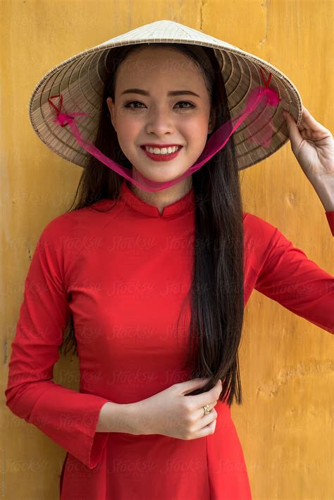 Vietnamese Woman In Ao Dai Traditional Costume And Conical Hat By