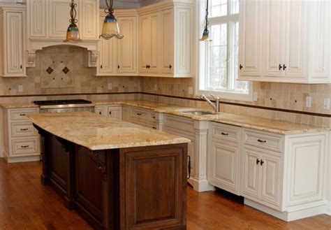 Tie this combination of white granite and white cabinets together with white marble subway tiles for a pristine contemporary. Colonial Gold Granite | Granite Countertops | Granite Slabs