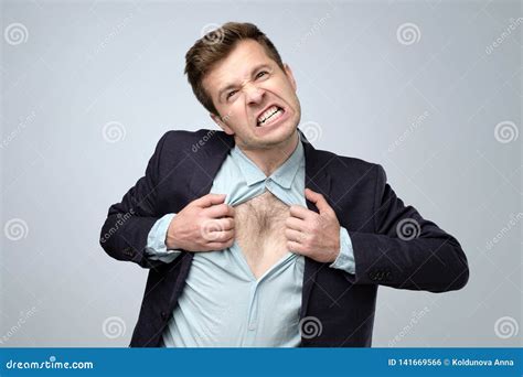 Young Caucasian Man Tearing His Shirt In Anger Stock Photo Image Of